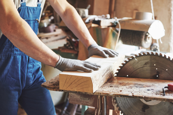 Man sawing wood